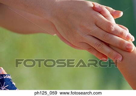 Hands of a parent and child View Large Photo Image Stock Photo - Hands of a parent and child. Fotosearch