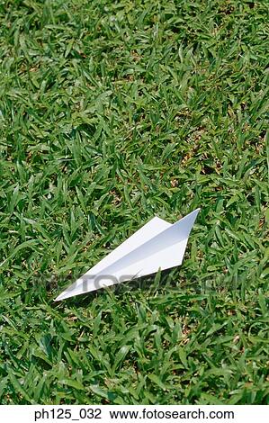 Paper airplane on grass patch, close-up View Large Photo Image Stock Image - Paper airplane on grass patch, close-up. Fotosearch