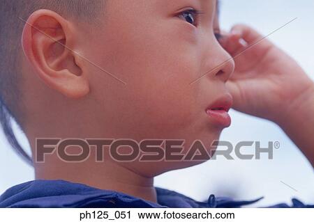 Portrait of a young Asian boy, close-up View Large Photo Image Stock Image - Portrait of a young Asian boy, close-up. Fotosearch