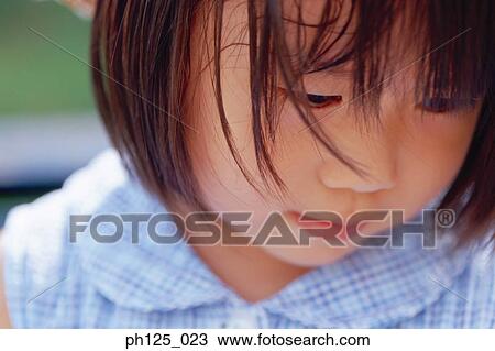 Portrait of a young Asian girl, close-up View Large Photo Image Stock Image - Portrait of a young Asian girl, close-up. Fotosearch