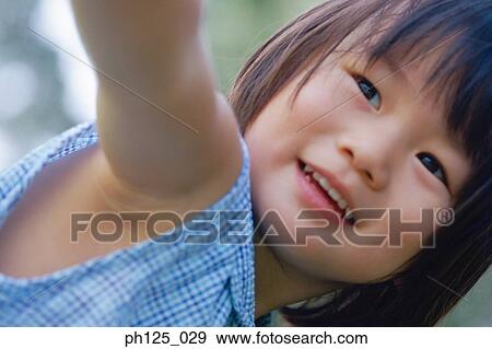 Stock Photo - Portrait of a young Asian girl, close-up. Fotosearch