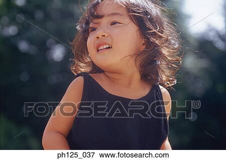 Portrait of a young Asian girl, close-up View Large Photo Image Stock Photo - Portrait of a young Asian girl, close-up. Fotosearch