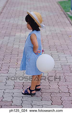 Picture - Portrait of a young Asian girl holding a balloon. Fotosearch