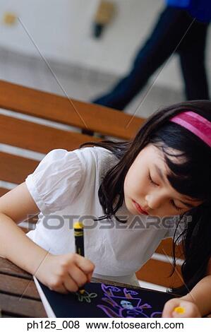 Portrait of a young girl drawing View Large Photo Image Stock Photo - Portrait of a young girl drawing. Fotosearch