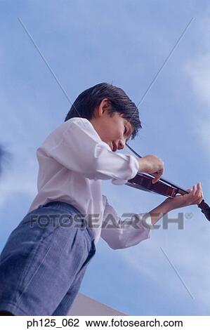 Young Asian boy playing violin View Large Photo Image Stock Image - Young Asian boy playing violin. Fotosearch
