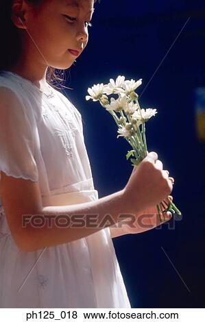 Young girl holding flowers View Large Photo Image Stock Photo - Young girl holding flowers. Fotosearch