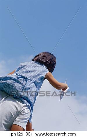 Young girl on father's shoulder, holding paper airplane, low angle view View Large Photo Image Stock Image - Young girl on father's shoulder, holding paper airplane, low angle view. Fotosearch