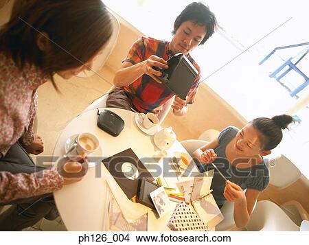 Friends gathering at a café View Large Photo Image Picture - Friends gathering at a café. Fotosearch