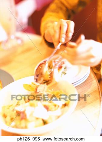 Man picking salad with fork and spoon View Large Photo Image Stock Photography - Man picking salad with fork and spoon. Fotosearch
