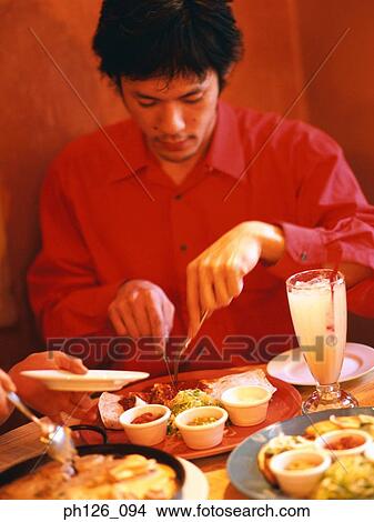 Man slicing Fajita with fork and knife View Large Photo Image Picture - Man slicing Fajita with fork and knife. Fotosearch