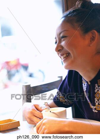 Side profile of a young woman smiling View Large Photo Image Stock Image - Side profile of a young woman smiling. Fotosearch