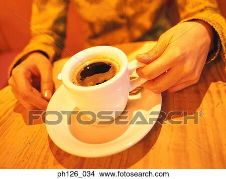 Woman holding a cup of coffee, mid section View Large Photo Image Picture - Woman holding a cup of coffee, mid section. Fotosearch
