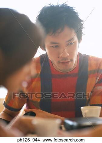 Young couple at a café View Large Photo Image Picture - Young couple at a café. Fotosearch