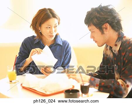 Young couple eating at a café View Large Photo Image Picture - Young couple eating at a café. Fotosearch