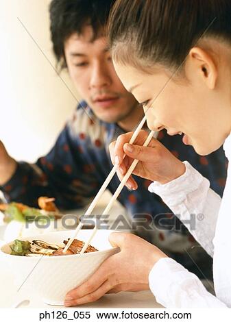 Young couple eating at a café View Large Photo Image Stock Photography - Young couple eating at a café. Fotosearch