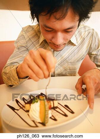 Young man picking the dessert View Large Photo Image Stock Image - Young man picking the dessert. Fotosearch