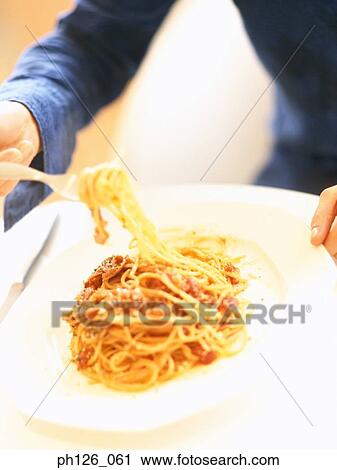 Young woman eating pasta with fork View Large Photo Image Stock Image - Young woman eating pasta with fork. Fotosearch