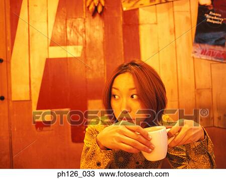 Young woman holding a coffee cup View Large Photo Image Stock Image - Young woman holding a coffee cup. Fotosearch