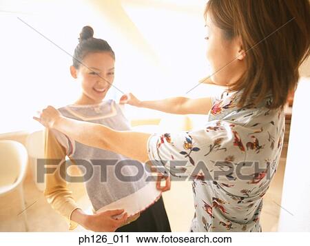 Young women showing off her new blouse View Large Photo Image Stock Image - Young women showing off her new blouse. Fotosearch