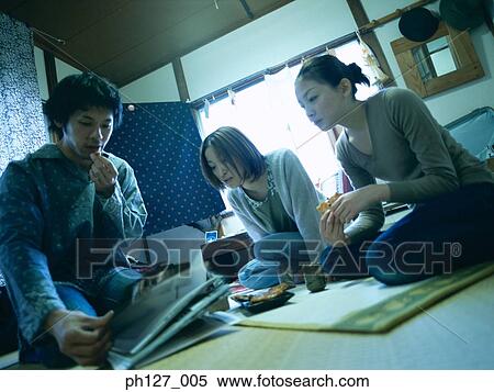 Friends gathered in a room View Large Photo Image Stock Photography - Friends gathered in a room. Fotosearch