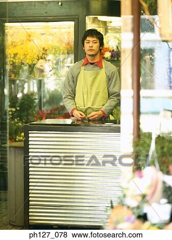 Male florist in the shop View Large Photo Image Stock Photo - Male florist in the shop. Fotosearch