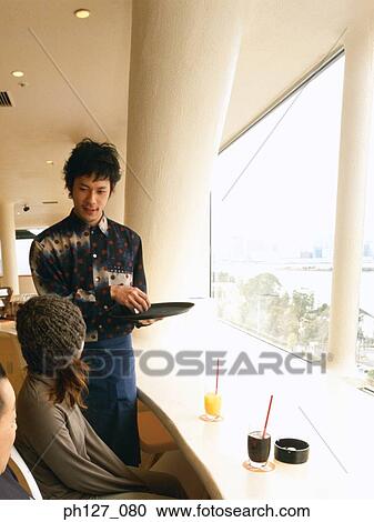 Male waiter presenting bill to customers View Large Photo Image Stock Image - Male waiter presenting bill to customers. Fotosearch