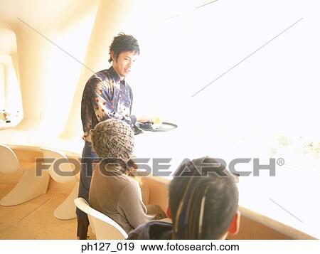 Male waiter serving customers View Large Photo Image Stock Photo - Male waiter serving customers. Fotosearch