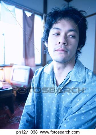 Portrait of a young Asian man, looking away View Large Photo Image Stock Photo - Portrait of a young Asian man, looking away. Fotosearch