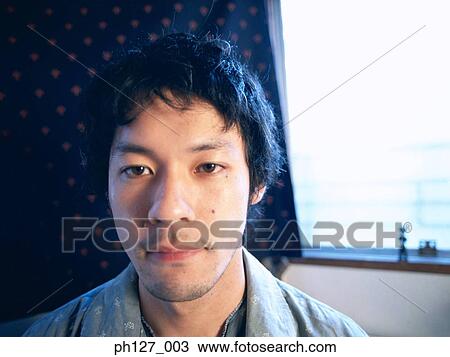 Stock Image - Portrait of a young Asian man. Fotosearch