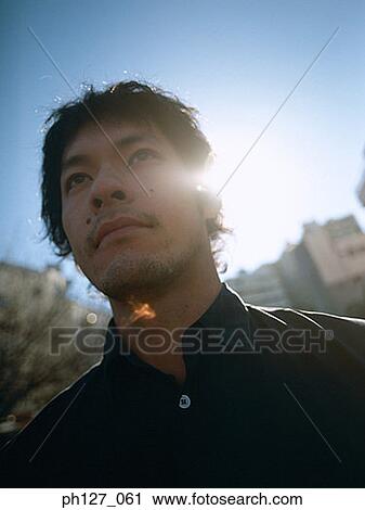 Stock Image - Portrait of a young Asian man. Fotosearch