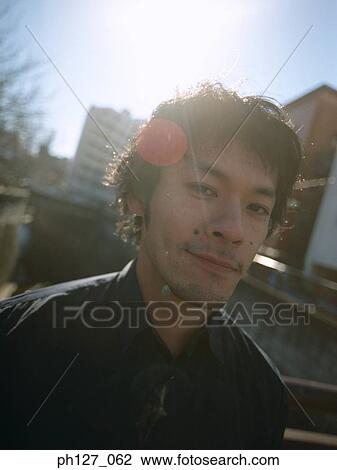 Portrait of a young Asian man View Large Photo Image Stock Image - Portrait of a young Asian man. Fotosearch