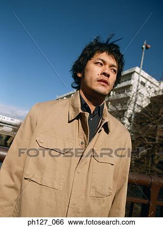 Stock Photograph - Portrait of a young Asian man. Fotosearch