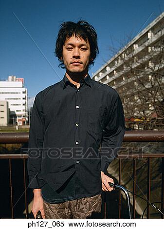 Portrait of a young Asian man View Large Photo Image Stock Photography - Portrait of a young Asian man. Fotosearch