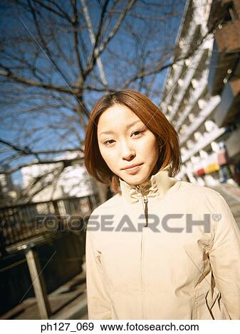 Portrait of a young Asian woman View Large Photo Image Stock Photo - Portrait of a young Asian woman. Fotosearch