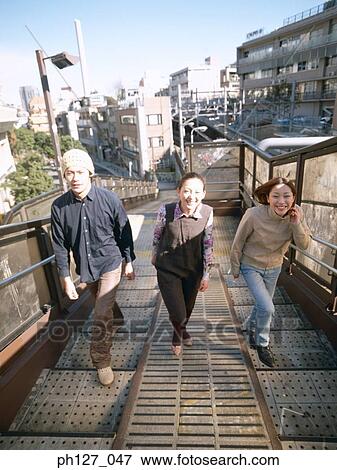 Three friends walking up steps View Large Photo Image Stock Photo - Three friends walking up steps. Fotosearch
