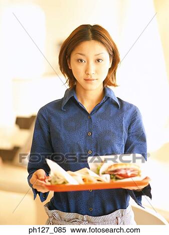 Stock Photography - Waitress holding a tray of fast food. Fotosearch