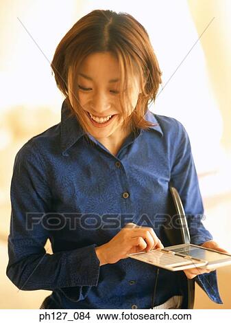 Waitress taking orders using digital device View Large Photo Image Picture - Waitress taking orders using digital device. Fotosearch