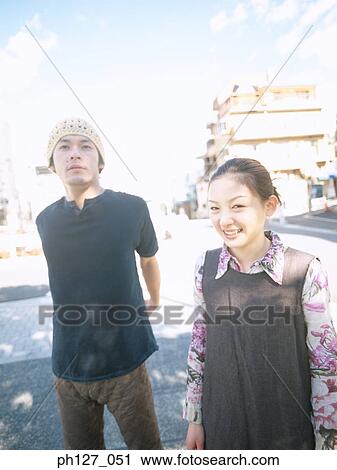 Young couple, looking at camera View Large Photo Image Stock Image - Young couple, looking at camera. Fotosearch
