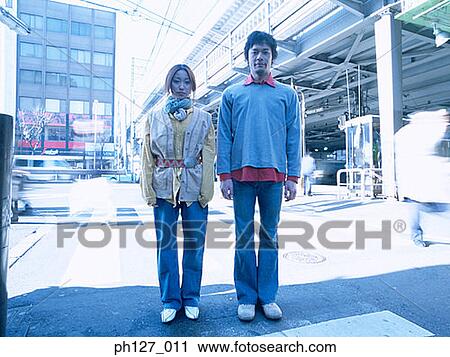 Young couple standing in the middle of the road View Large Photo Image Stock Image - Young couple standing in the middle of the road. Fotosearch
