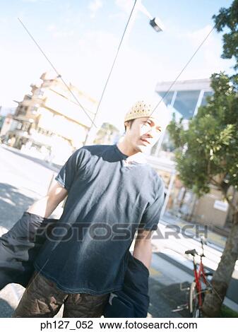 Stock Image - Young man in a park. Fotosearch