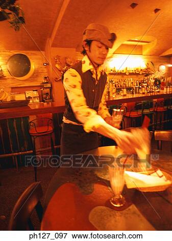 Young man in cowboy hat clearing table at the bar counter View Large Photo Image Stock Photo - Young man in cowboy hat clearing table at the bar counter. Fotosearch