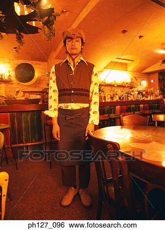 Young man in cowboy hat standing at a bar counter View Large Photo Image Stock Photograph - Young man in cowboy hat standing at a bar counter. Fotosearch