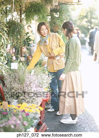 Young women at a florist View Large Photo Image Stock Image - Young women at a florist. Fotosearch