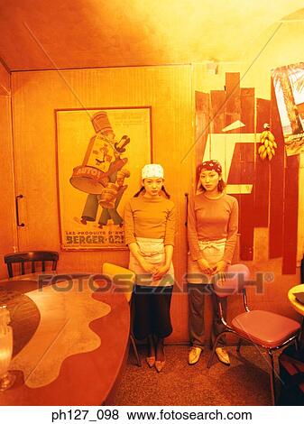 Young women wearing bandana standing at a restaurant View Large Photo Image Stock Photo - Young women wearing bandana standing at a restaurant. Fotosearch