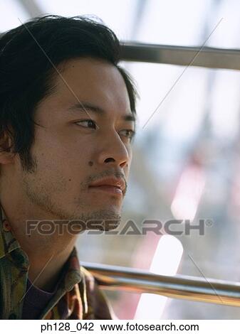 Stock Image - Portrait of a young Asian man . Fotosearch