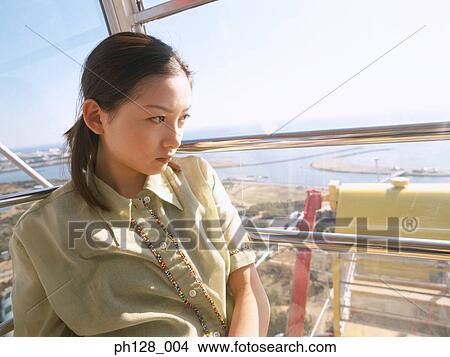 Picture - Portrait of a young Asian woman looking away. Fotosearch