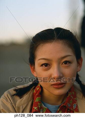 Portrait of a young Asian woman, close-up View Large Photo Image Picture - Portrait of a young Asian woman, close-up. Fotosearch