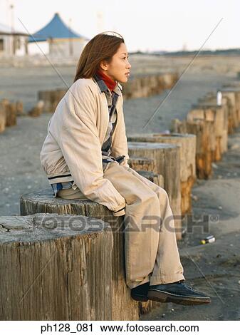 Stock Image - Portrait of a young Asian woman, side profile. Fotosearch