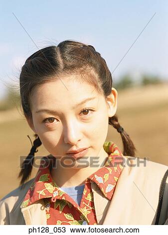 Stock Image - Portrait of a young Asian woman . Fotosearch