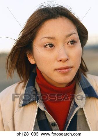 Stock Image - Portrait of a young Asian woman, close-up. Fotosearch
